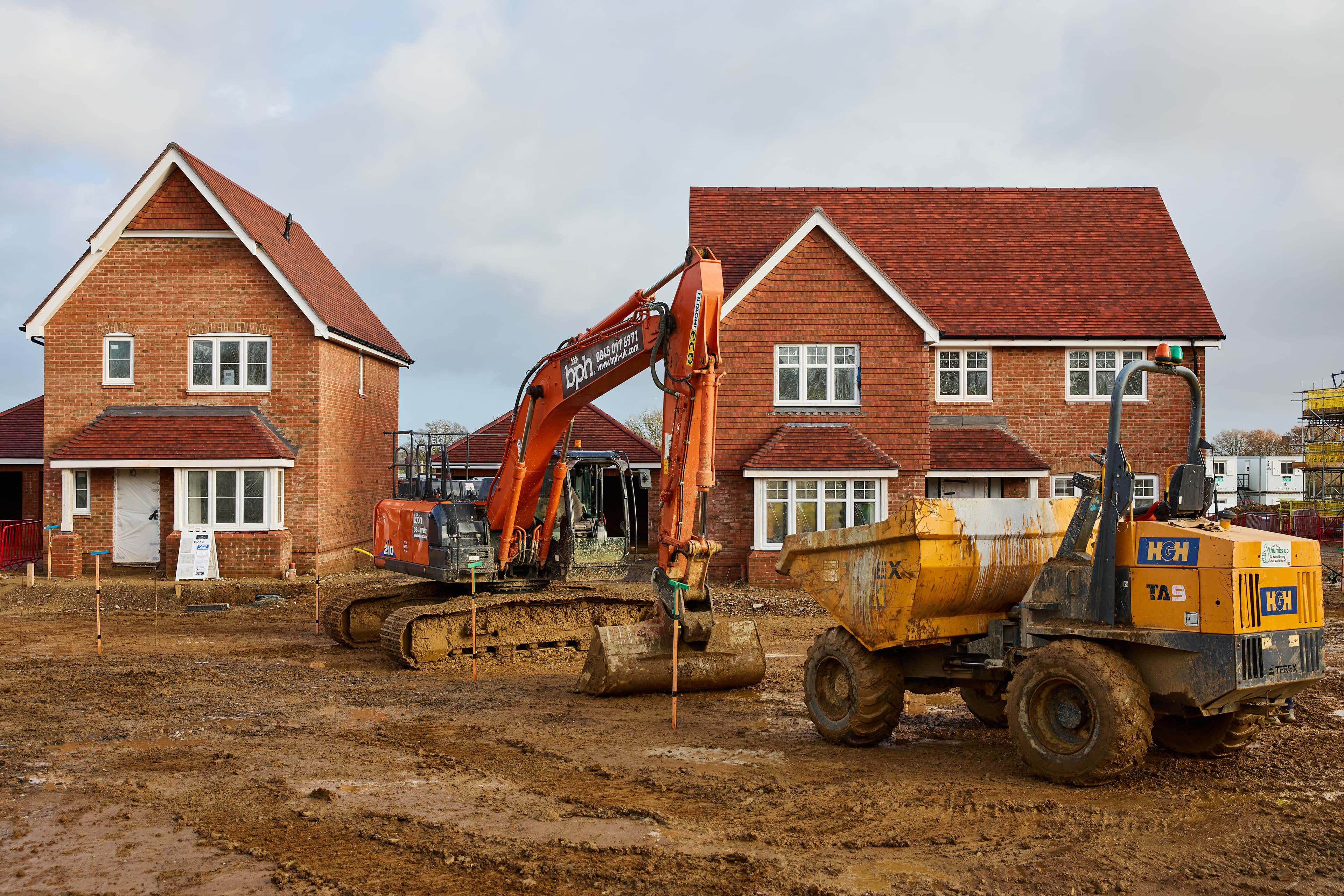 Excavator and dumper working on a rural housing development.